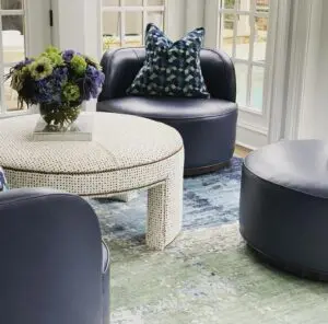 A blue living room furniture set with a flower vase on top of the table